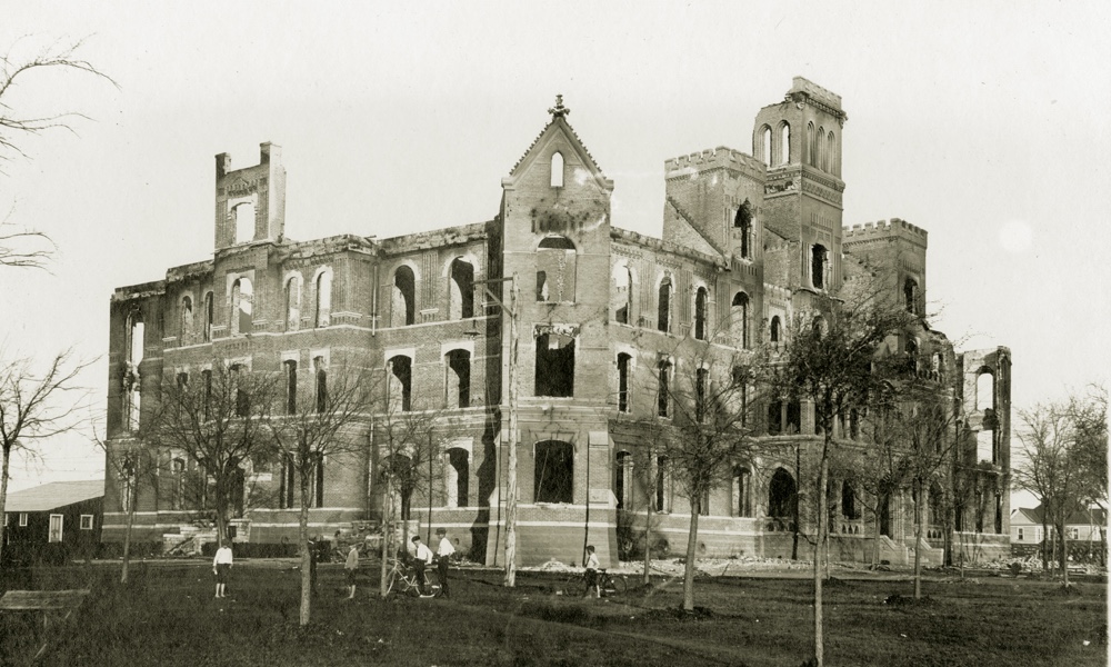 The charred remains of a four-story stone building, TCU's Waco campus main building after a fire