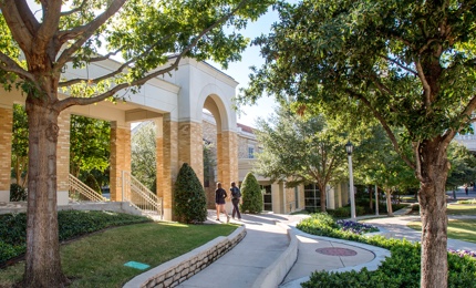 Two Female students walking through the commons buildings