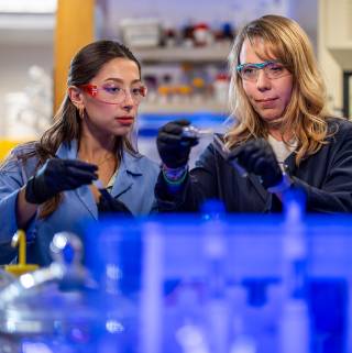 Two people working in a lab.