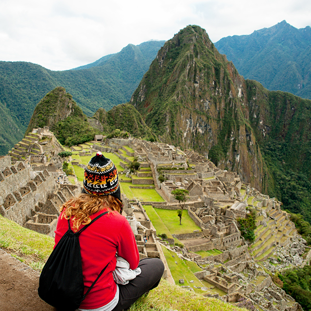 A young woman looks over the landscape of Machu Picchu (Getty)