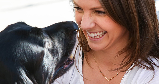 Woman smiling with a dog
