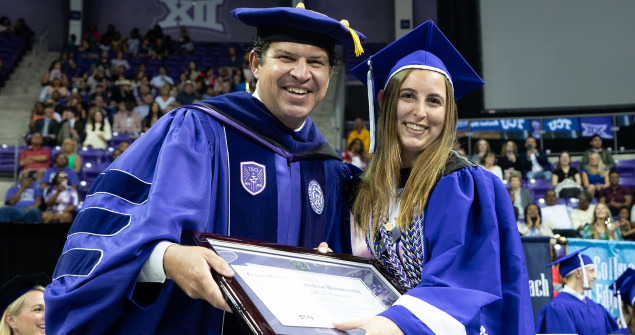 Chancellor Pullin awards diploma to female student