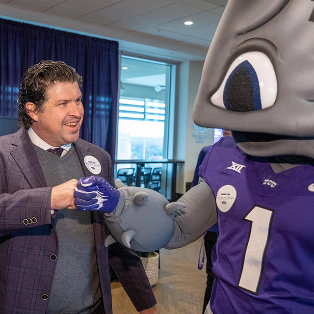 Daniel Pullin gives SuperFrog a fist bump